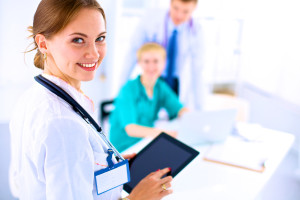 Young woman doctor holding a tablet pc .