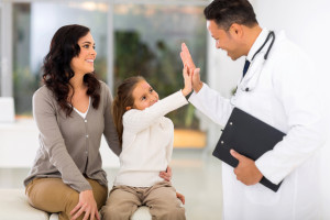 little girl and paediatrician doing high five