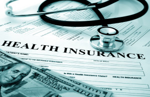 Health insurance form with money and stethoscope
